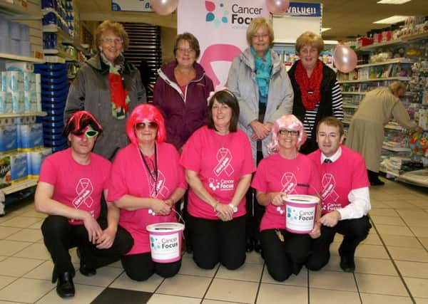 Ena Millar, Heather Hutton, Vivien Pundike and Jean Kennedy, from Cancer Focus, are pictured with Wyse Byse staff James Adger, Sally White, Arlene McAllister, Jean Simmons and Alistair Gilmore dressed in pink raising money for the charity. INBT44-219AC