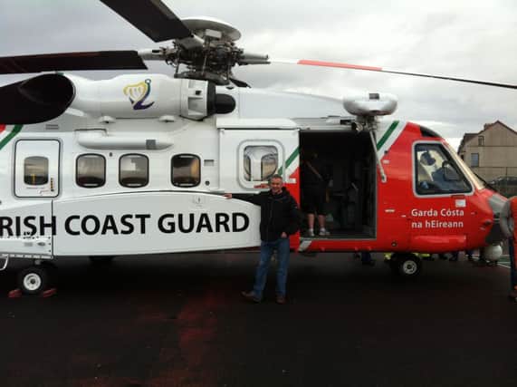 John Lynn pictured with the Irish Coastguard helicopter.