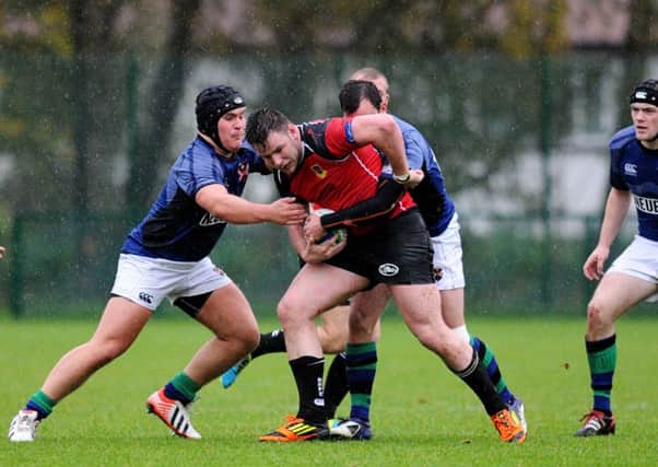 Ballymena's Adrian Hamilton tries to avoid a tackle from Queen's Johnny Craig. Picture: Press Eye.