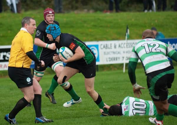 City of Derry flanker Richard Baird escapes this tackle from Nass player Peter Osborne on his way to scoring their second from of the match on Saturday. INLS4413-172KM