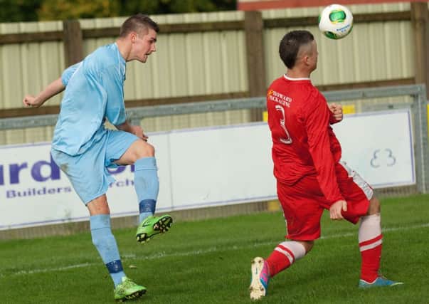 Loughgall defender Adam Rodgers blocks this cross from Institute's Tom Carlin. INLS4413-182KM