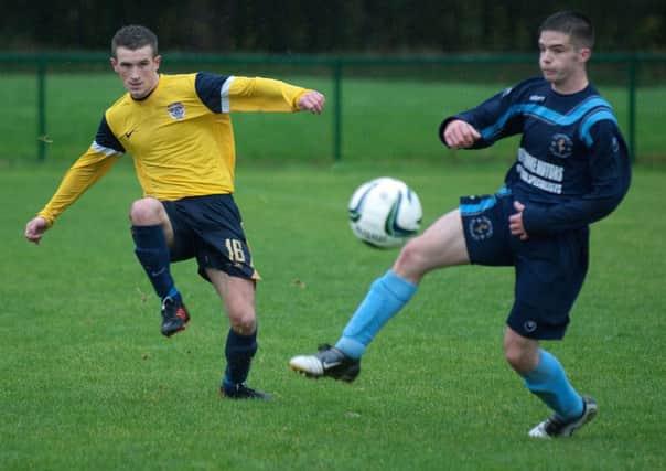Gary Harris sets up an attacking move for Caw during their match against Tullyally colts on Saturday. INLS4413-185KM