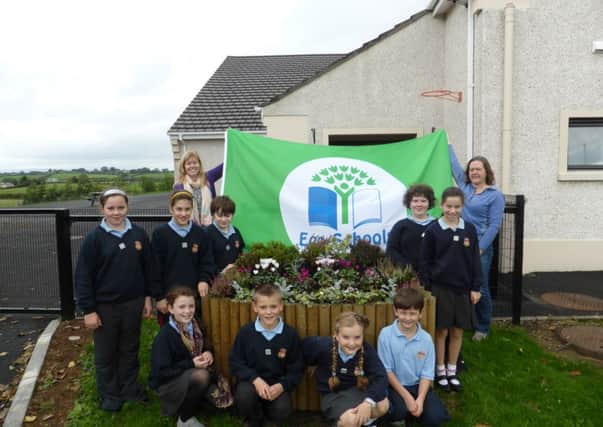 Staff and pupils with Eco Flag.