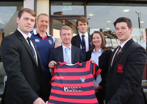 Ryan Gregg and Elaine Nicholl of Rainey & Gregg present a new set of jerseys to Ballymena Academy 1st XV captain Duncan Maguire (left) and vice-captain Justin Jolly while looking on are team coach John Andrews and 1st XV player Philip Stevenson. INBT 44-172CS