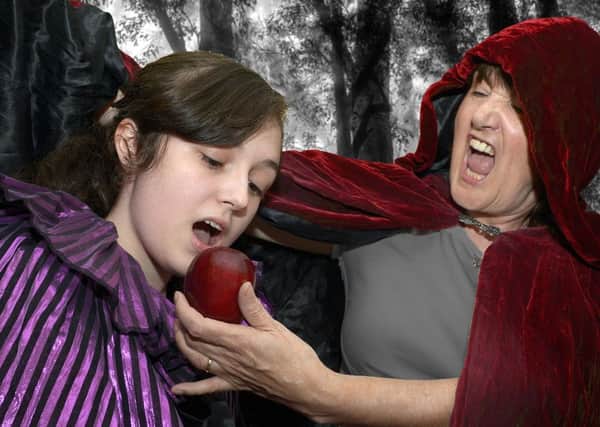 Snow White (Kelly Skillen) is tempted to eat the poisoned apple by wicked Queen Lucretia (Linda McWilliams) at rehearsals for Banbridge Musical Society's production of Snow White  © Edward Byrne Photography INBL44-202EB