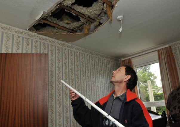 Wilson Gardiner looks at the home in his ceiling caused by vermin eating through plastic water pipes in his roof space. INLM44-126gc