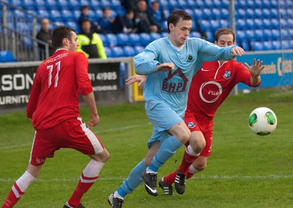 Institute's Darren McCauley wins this tussle for the ball during Saturday's match against Loughgall. INLS4413-178KM