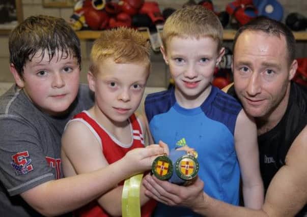 Lisburn Boxing Club members Jason Corry, Thomas Orr and Michael Agnew, who took part in the recent Ulster Nine Counties Championships, pictured with head coach Martin Laverty. US1344-503cd