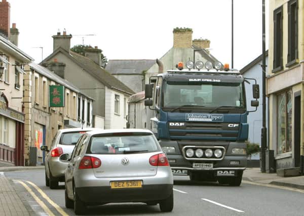 Traffic passing through the bottom of Main Street in Dungiven. LV34-728MML