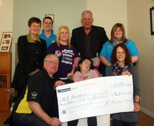 Denis McMichael presents a cheque for £742 to Debbie and Jade McAfee. Also included is Margaret Butler, Treasurer of Ballycastle Hospice, Francesca, David and Rachel McMichael and Bill Kernnedy, clerk of the course Armoy Road Races.INBM45-13 111L