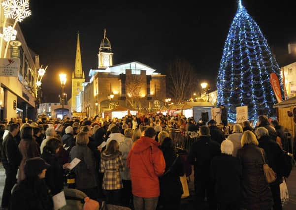 Christ Church rector, the Rev Paul Dundas welcomes the large crowd of Lisburn city centre shoppers who celebrated the real meaning of the season at a Community Carol Service in the open air around the Christmas tree in Market Square on Saturday 11th December.