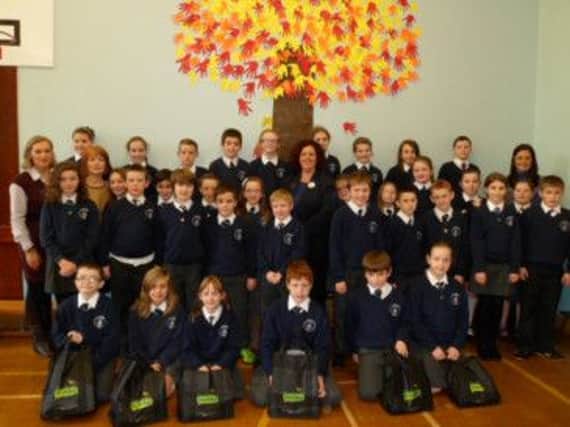 Year 7 pupils with their teachers Mrs Robinson and Mrs Thompson before heading out to distribute Harvest Gift Bags to the local senior citizens. Also included within the picture is Jackie Brogan from Tescos in Ballymoney who provided the reusable bags.