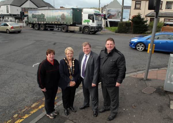 At the Dunmurry crossroads are Lisburn Mayor Margaret Tollerton, and Johnathan Craig MLA, along with Wendy Burke, sub post mistress Dunmurry, and Billy Thompson, chairman of Dunmurry Community Association. INUS4413-LIGHTS