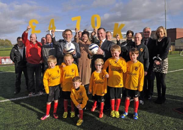 Social development minister, Nelson McCausland, at the announcement of the £461 funding for Lurgan Town Fooball Club with club members, players and guests. INLM44-132gc