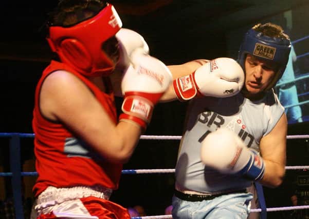 Steven Dowds (red) and Chris Bracken trade blows at the recent white collar fight night raising money for Cancer Focus. INBT45-214AC
