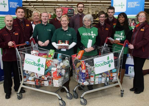 Staff and volunteers with Ballymena Foodbank, pictured along with Sainsburys staff during their recent collection in the local store. Included is Ballymena foodbank assistant manager Darren O'Rourke. INBT45-223AC