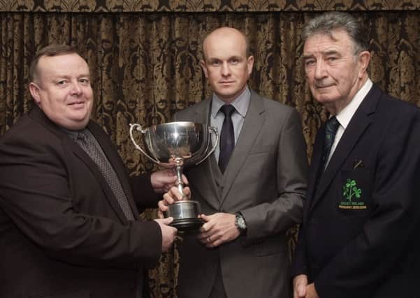 Dessie McCallion, left, presenting the Radio Foyle Cup for the Player of the Year to Niall McDonnell, of Coleraine, at the annual presentation dinner held by the North West Cricket Union in the White Horse Hotel. Included is Robin Walsh, President of Cricket Ireland. INLS4513-104KM
