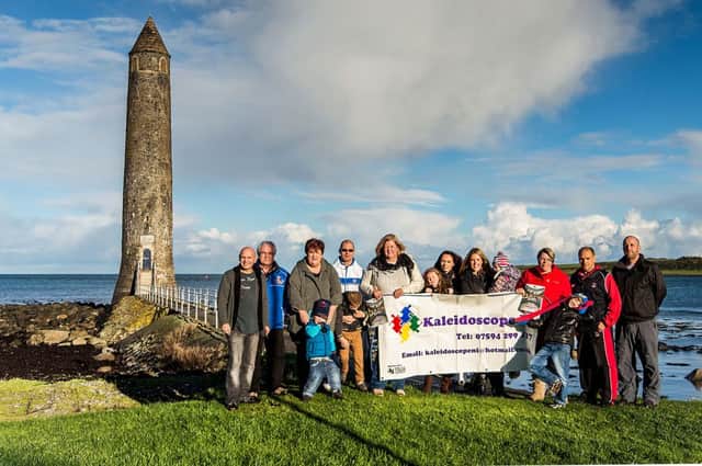 Members of Kaleidoscope NI and Larne Through a Lens pictured at Chaine Memorial Tower to promote the new calendar.  INLT 45-695-CON