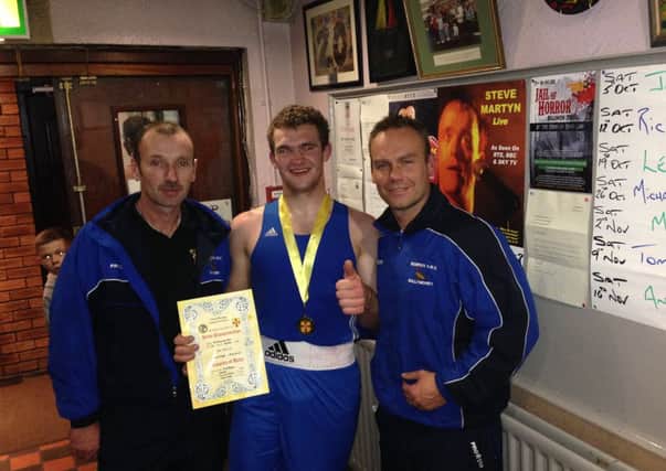 Ballymoney Scorpion Club's new boxing champion Karol Dlugosz is congratulated. Also included is coach Alan 'Spike' Martin (right).