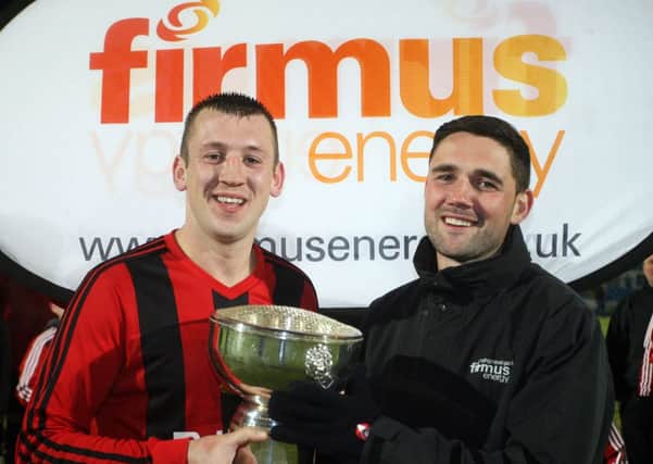 David Fusco of Firmus Energy presents the Top 4 trophy to Harryville Homers captain Gary Bones, after they beat Carniny Rangers 2-0. INBT46-256AC