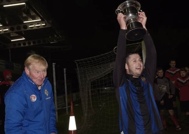 BBOB captain Nicky Cooke holds the Summer Cup aloft after their victory over Drummond at The Riverside Stadium on Friday night. INLS4613-159KM
