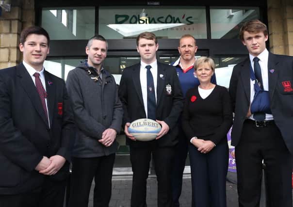 Robinson's Supermarket store manager Gary Olphert and floor manager Elaine Kirk with Ballymena Academy 1st XV captain Duncan Maguire (centre), vice-captain Justin Jolly (left), player Philip Stevenson (right) and team coach John Andrews at last week's announcement that Robinson's are to be one of the Academy Rugby sponsors. INBT 44-173CS