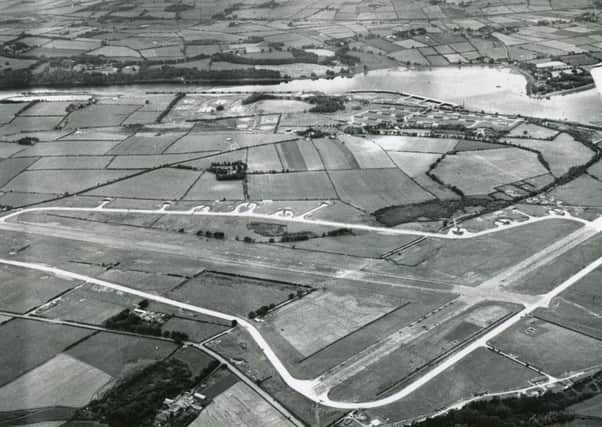 A wartime aerial view of HMS Shrike, also known as Royal Naval Air Station Maydown. The airfield had been built originally for the RAF. The Lisahally wharves are visible to the top of the photo and some of the barrage balloons that protected the city and the port may also be seen.