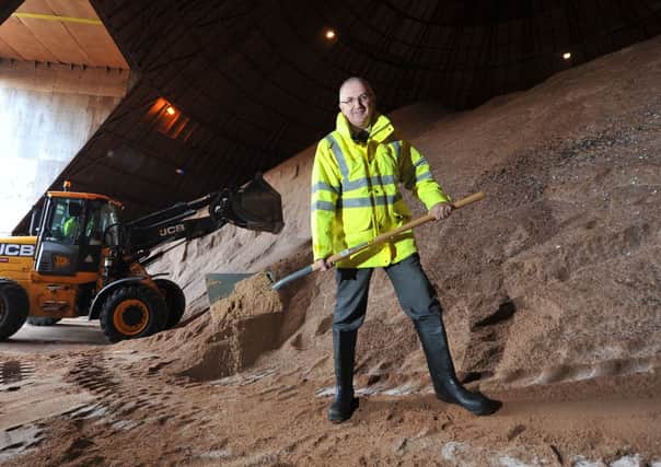 Regional Development Minster Danny Kennedy at Roads Service salt barn in Belfast where just some of the 110,000 tonnes of salt are stored ready for use on roads this winter. Picture: Michael Cooper