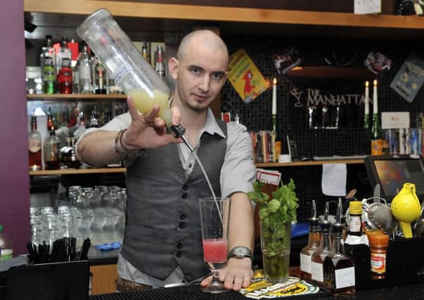Johnathan Haggerty mixes a cocktail at The Manhattan. INLM46-124gc