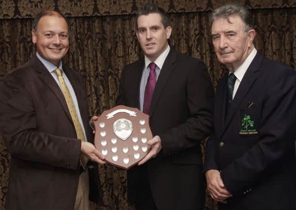 Warren Deutrom, left, CEO of Cricket Ireland, presenting the Premiership Bowling Shield to Johnny Robinson, of Fox Lodge Cricket Club, at the annual dinner held by the North West Cricket Union in the White Horse Hotel. Included is Robin Walsh, President of Cricket Ireland. INLS4513-108KM