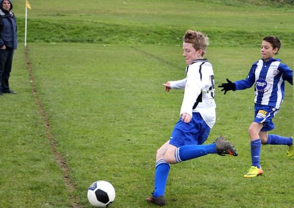 A Northend United under-15 player rushes to try to prevent the ball crossing the dead ball line during Saturday's match against Coleraine. INBT 47-906H