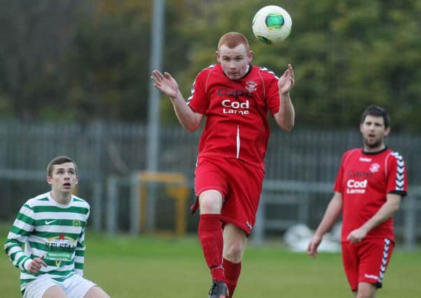 Larne's Eamon Hughes clears the ball against Donegal Celtic. Photo: Presseye