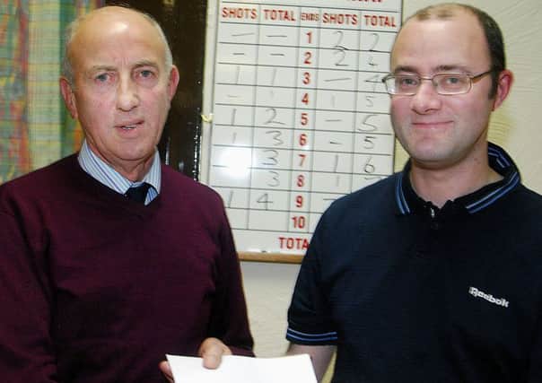 Mid Antrim Zone convenor Tom Morrison presents a cheque to David Morrison to be used for expenses when he plays for Ireland in the British Isles team. INBT 47-808H