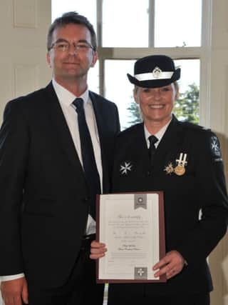 St. John Ambulance volunteer Ruth McFaul received a certificate for her 17 years' service at an awards ceremony at Belfast Castle. Also pictured is Gary McFaul. INLT 46-652-CON
