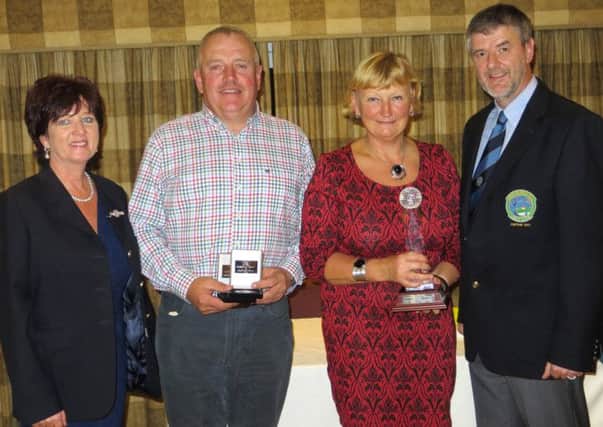Robert Patterson and Diane Patterson receiving the Captain's Mixed Trophy from Lady Captain Noeleen Houston and Gents Captain Glenn Willis.