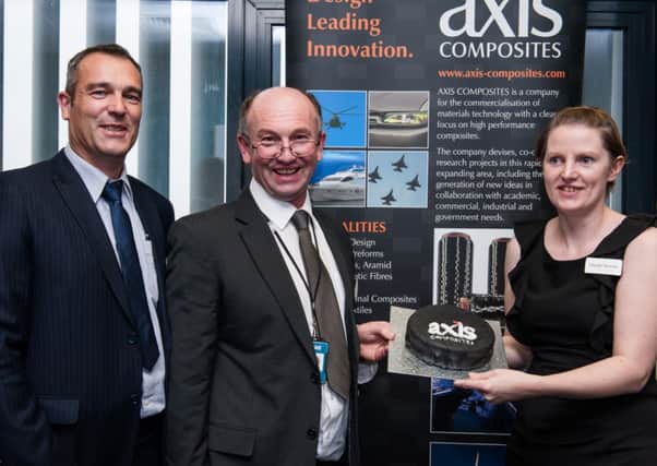 Axis Composites chairman Mark Fekkes, managing director Steven Kirby , and Dr Glenda Stewart, with a cake baked specially for the announcement of the firm's capability to weave hi-tech carbon fibre fabrics to meet the demand for strong yet lightweight new materials. INLT 47-625-CON