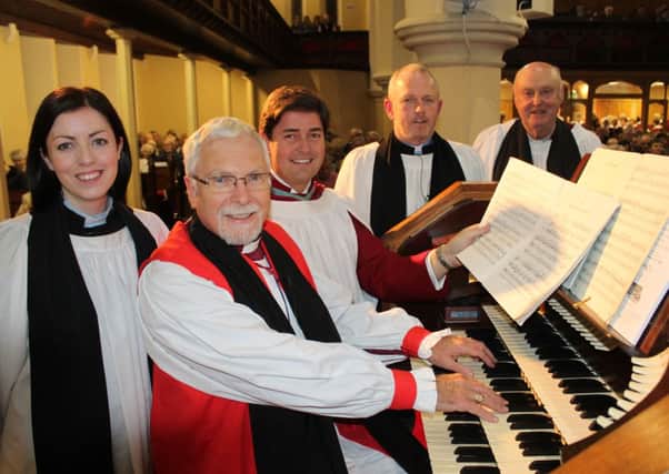 Bishop of Down and Dromore, Rt Rev Harold Miller checks out the church organ before the service of re-dedication at Shankill Parish Church
along with, from left, Rev Clare Kakuru, Karl McCambley, musical
director, Rev Geoff Wilson, rector and Canon John Moore. INLM47-8408.