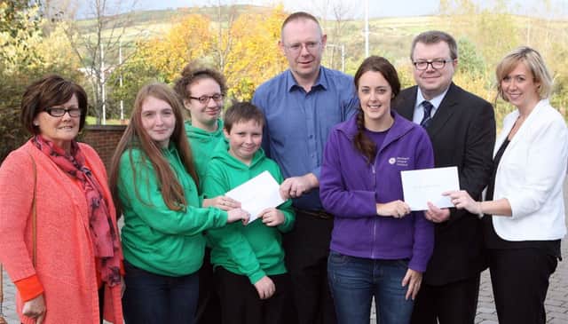 Kate Pollock, Grace Daily, Kenzie Twamley and Thomas McKnight from the All Star Special Olympics Club; Deirdre Mally of the NI Hospice and Noeleen McErlane from Pretty n Pink receive cheques from Mark McKnight and Myles McKeown.
