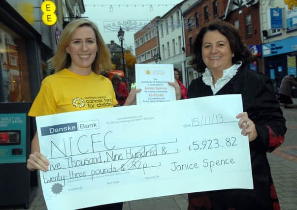 Janice Spence, recently returned from her charity walk on The Great Wall of China, hands over a cheque for £5923.82 to Amanda Steele from the Northern Ireland Cancer Fund for Children. INUS4713-WALK