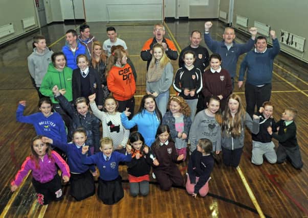Clann Eireann Youth Club members celebrate the news off funding for a new club. Included are, club chairman Donal McCarthy, Dee McKerr, youth club chair and Stephen McNally, leader in charge. INLM47-129gc