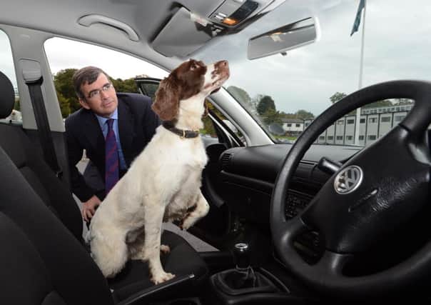 Assistant Chief Constable Drew Harris watches as Rosie, a PSNI cash and drugs search dog, finds drugs in a car, at the original launch of Operation Torus in 2012.