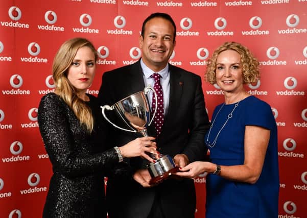 Aileen Reid, left, is presented with her Vodafone Athlete of the Year award at the Triathlon Ireland Awards Dinner in the Aviva Stadium by Minister for Transport, Tourism and Sport Leo Varadkar T.D., and Anne OLeary, CEO of Vodafone Ireland.