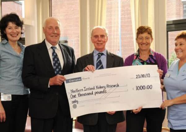 From left:  Linda Trouton, co-ordination, Belfast City Hospital; Ben Stewart, William Thompson, member of Northern Ireland Kidney Research Fund, Lorraine Harper, Susie McWhinney, renal nurse, Belfast City Hospital. The cheque for £1,000 was the sum donated to the Northern Ireland Kidney Research Fund instead of presents for Lorraine Harper who celebrated her 50th birthday and her father Ben Stewart who was 80-years-old.. INLT 47-656-CON