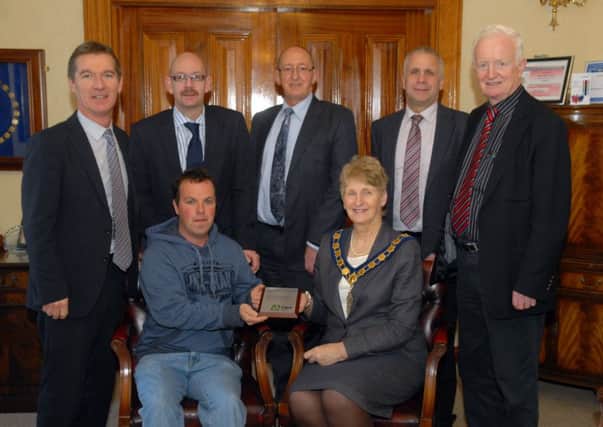 Tidy NI Local Hero Garnett McConnell receives his award from Council chairman Olive Mercer along with Council staff David Lindsay, Barry Patience, and Eric Morton, with Councillors Brendan Curran and Jim McElroy. INBLK4713-LOCAL