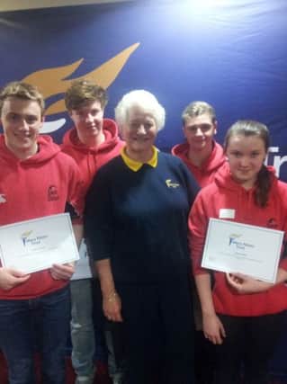 James Richardson (second on the left) receives a bursary award from Dame Mary Peters.