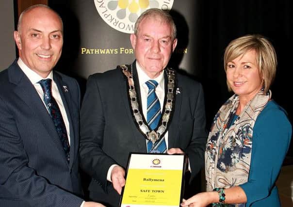 Ballymena has been recognised as a Safe Town  for people living with domestic abuse - pictured receiving the Onus Safe Town Award on behalf of Ballymena is Deputy Mayor  of Ballymena, Cllr James McClean with Irvine Abraham, Chair of Onus and Colette Stewart, Business Manager.