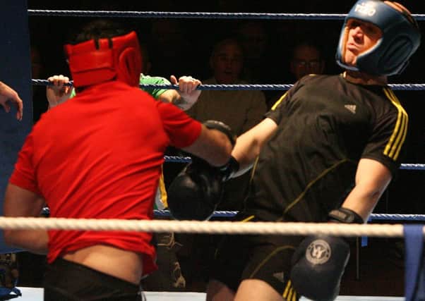 Barry Molloy (red) gets a sweet right hook in on Davy Doherty during their bout on Friday night.
