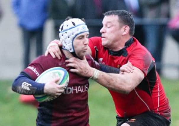 Carrick's Andy Kincaid gets to grips with his Academy opponent.