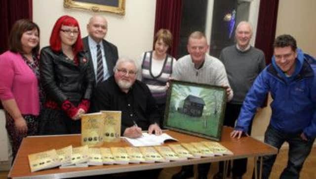 DAE YE KIN. Author of 'Kith & Kin', Alister McReynolds (seated), pictured at his book signing event in the Town Hall on Friday night along with his wife Eileen, daughter Kirsty, local Historian Alex Blair, Cllr Ian Stevenson, Corporate Services Officer Liz Johnston and Winston and Jonathan Frew.INBM48-13 134SC.