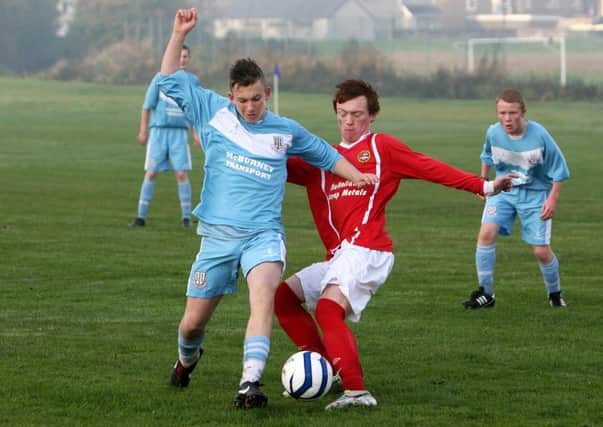 Carniny Youth player Adam Mairs tries to tackle Ballymena Youth player Robbie Perkins. INBT48-272ac